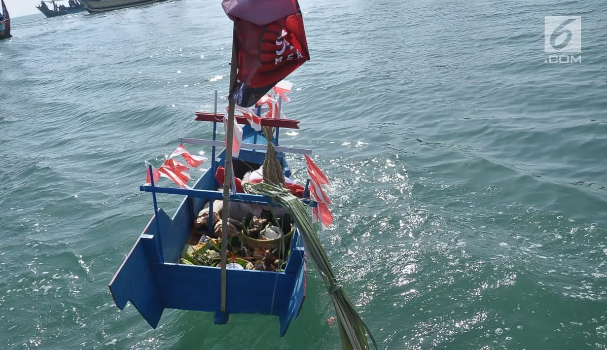 Kapal kecil berisi kepala kerbau terlihat saat ritual pesta laut nelayan Desa Sendang Sikucing Kendal, Jawa Tengah di muara pantai, Minggu (7/10). Ritual ini dilakukan setiap bulan Muharram. (Liputan6.com/Gholib)