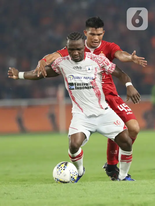 Pemain tengah Persija, Sandi Darma Sute (kanan) berebut bola dengan penyerang Persipura, Ibrahim Conteh pada lanjutan Shopee Liga 1 Indonesia 2019 di Stadion Utama Gelora Bung Karno, Jakarta, Kamis (28/11/2019). Persija unggul 1-0. (Liputan6.com/Helmi Fithriansyah)