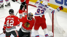 Pemain New York Rangers merayakan golnya usai membobol gawang Chicago Blackhawks saat pertandingan NHL di Chicago (15/11). Blackhawks unggul 6-3 atas Rangers. (AP/Charles Rex Arbogast)