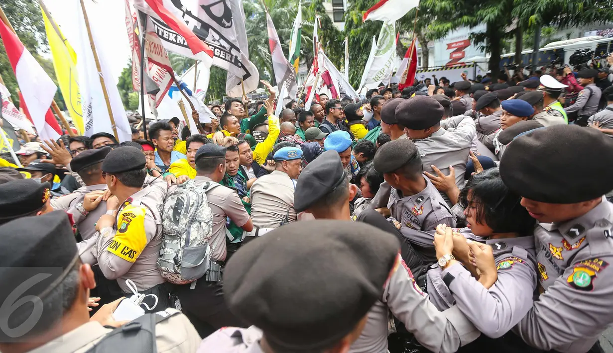 Suasana bentrokan antara polisi dan mahasiswa BEM Se-Jabodetabek di depan Istana Negara, Kamis (12/1). Dalam aksinya mereka menuntut Presiden Jokowi-JK untuk membuat kebijakan yang pro terhadap rakyat. (Liputan6.com/Faizal Fanani)