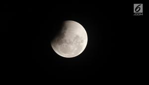 Pemandangan penumbra saat mulai menutupi permukaan bulan pada proses terjadinya gerhana bulan yang terlihat di atas langit Jakarta, Rabu (31/1). Gerhana Bulan Total ini disertai dengan Supermoon dan Blue Moon. (Liputan6.com/Arya Manggala)