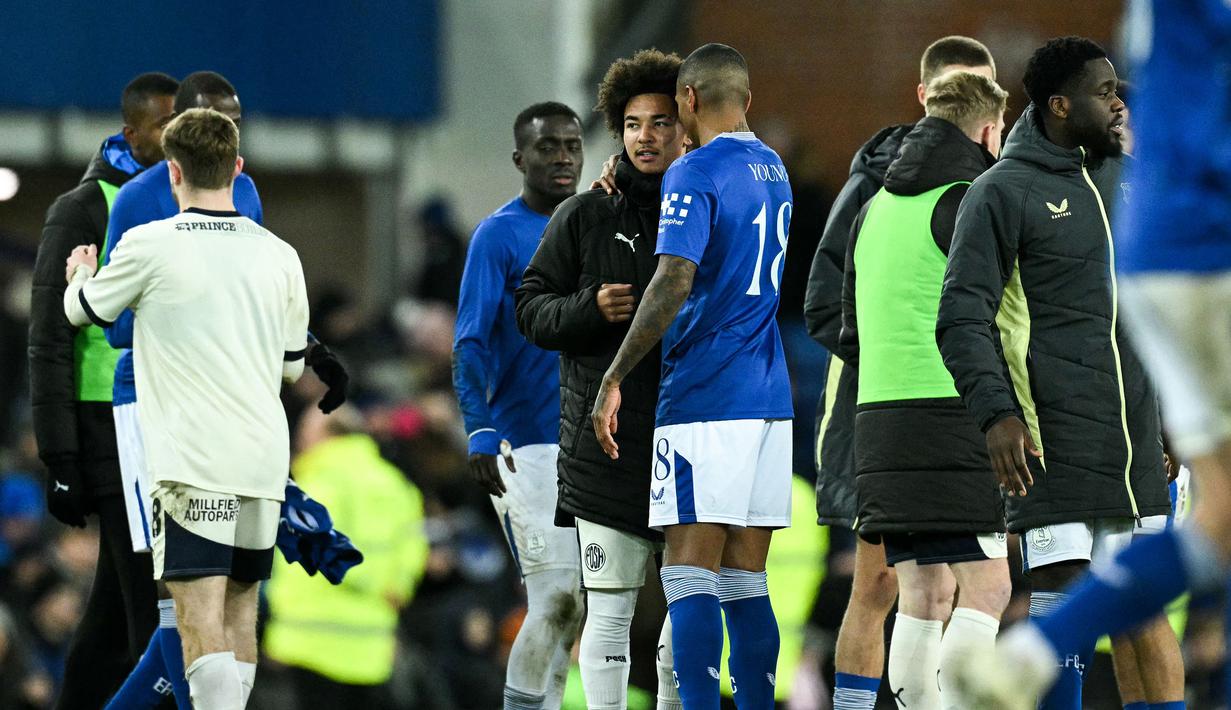 Pemain Everton, Ashley Young (tengah kanan) bertemu dengan pemain Peterborough United, Tyler Young yang merupakan putranya pada laga putaran ketiga Piala FA 2024/2025 di Goodison Park, Liverpool, Inggris, Jumat (10/01/2025) WIB. (AFP/Oli Scarff)