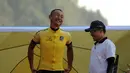 Kyosuke Takei (kiri) mengenakan kaos kuning di podium kemenangan etape I balap sepeda International Tour de Banyuwangi Ijen, (16/10/2014). (Liputan6.com/Helmi Fithriansyah)
