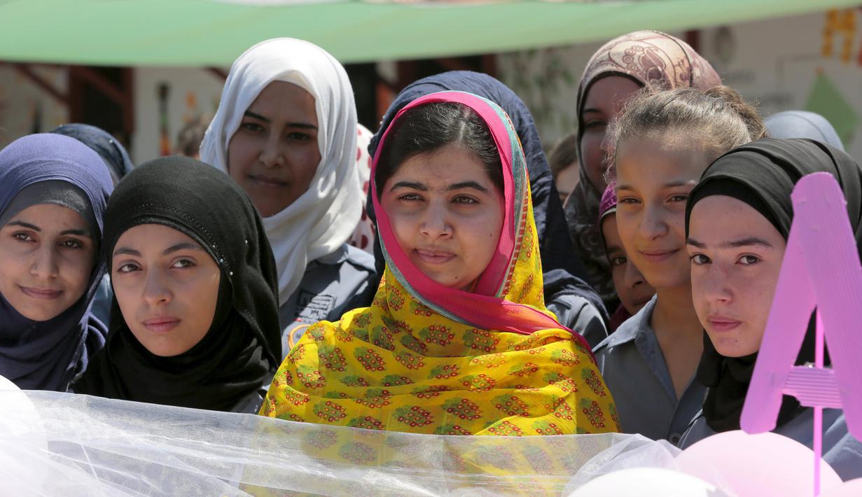 Peraih nobel perdamaian Malala Yousafzai (tengah), berpose dengan sejumlah pengungsi perempuan saat mengunjungi Lebanon, 12 Juli 2015. Selain merayakan ulang tahunnya, Malala juga membuka sekolah di Lebanon. (REUTERS/Jamal Saidi) 