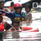 Petugas Pemadam Kebakaran mengevakuasi anak-anak korban banjir dengan menggunakan ban di kawasan Karet Pasar Baru Barat, Jakarta, Selasa (25/2/2020). Banjir yang terjadi sejak subuh akibat luapan Kanal Banjir Barat tersebut merendam ratusan rumah hingga setinggi dua meter. (merdeka.com/Arie Basuki)