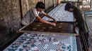Para pekerja membuat batik sablon di Sidoarjo, Jawa Timur, Sabtu (1/10/2022). Indonesia akan memperingati Hari Batik Nasional pada 2 Oktober. (JUNI KRISWANTO/AFP)