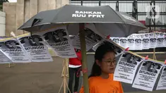 Aktivis Pekerja Rumah Tangga (PRT) melakukan aksi di depan Gedung DPR, Senayan, Jakarta, Rabu (23/8/2023). Aksi dengan memasang instalasi 580 jemuran anggota DPR itu sebagai simbol kepada pimpinan, ketua fraksi, dan anggota DPR RI untuk segera membahas dan mengesahkan Rancangan Undang-Undang Perlindungan Pekerja Rumah Tangga (RUU PPRT). (Liputan6.com/Johan Tallo)