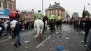 Polisi berkuda dikerahkan membubarkan suporter West Ham United yang menyerang bus skuat Manchester United di depan Stadion Boleyn Ground, London, Selasa (10/5). Sejumlah hooligan West Ham memblokir jalan dan menyerang bus tim tamu. (Reuters/Eddie Keogh)