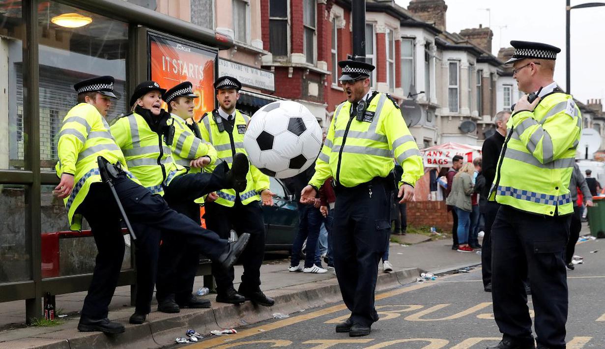 Polisi bermain bola jelang pertandingan antara West Ham United melawan MU di Stadion Upton Park, London, (10/5/2016). (Reuters/Eddie Keogh)