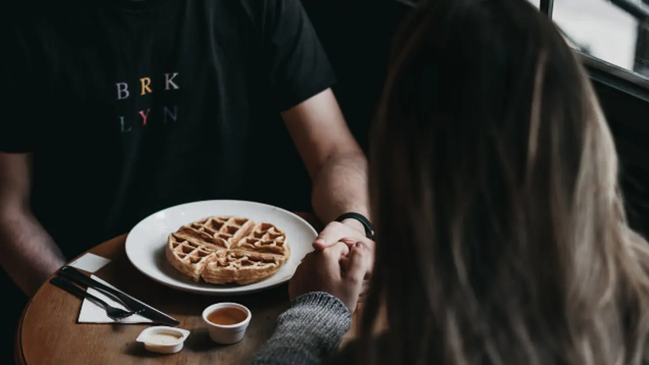 Couple go for a breakfast with waffles