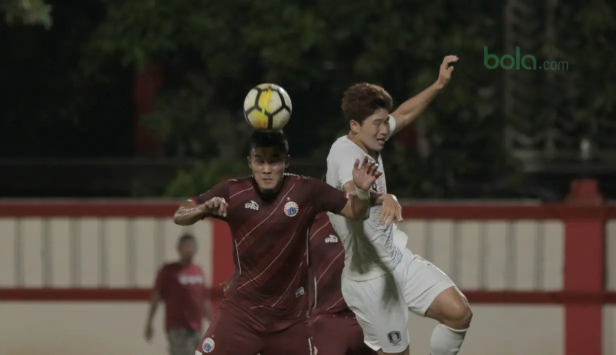 Pemain Persija Jakarta, Gunawan Dwi Cahyo (kiri) menghalau bola dari pemain Korea Selatan U-23 pada laga uji coba di Stadion PTIK, Jakarta, (21/6/2018). Persija kalah 1-3. (Bola.com/ Nick Hanoatubun)