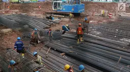 Pekerja merangkai besi behel untuk pembangunan proyek Rumah Susun Pasar Rumput di Manggarai, Jakarta, Jumat (21/7). Sebanyak 12 pasar tradisional di Jakarta akan diubah menjadi pasar modern. (Liputan6.com/Immanuel Antonius)