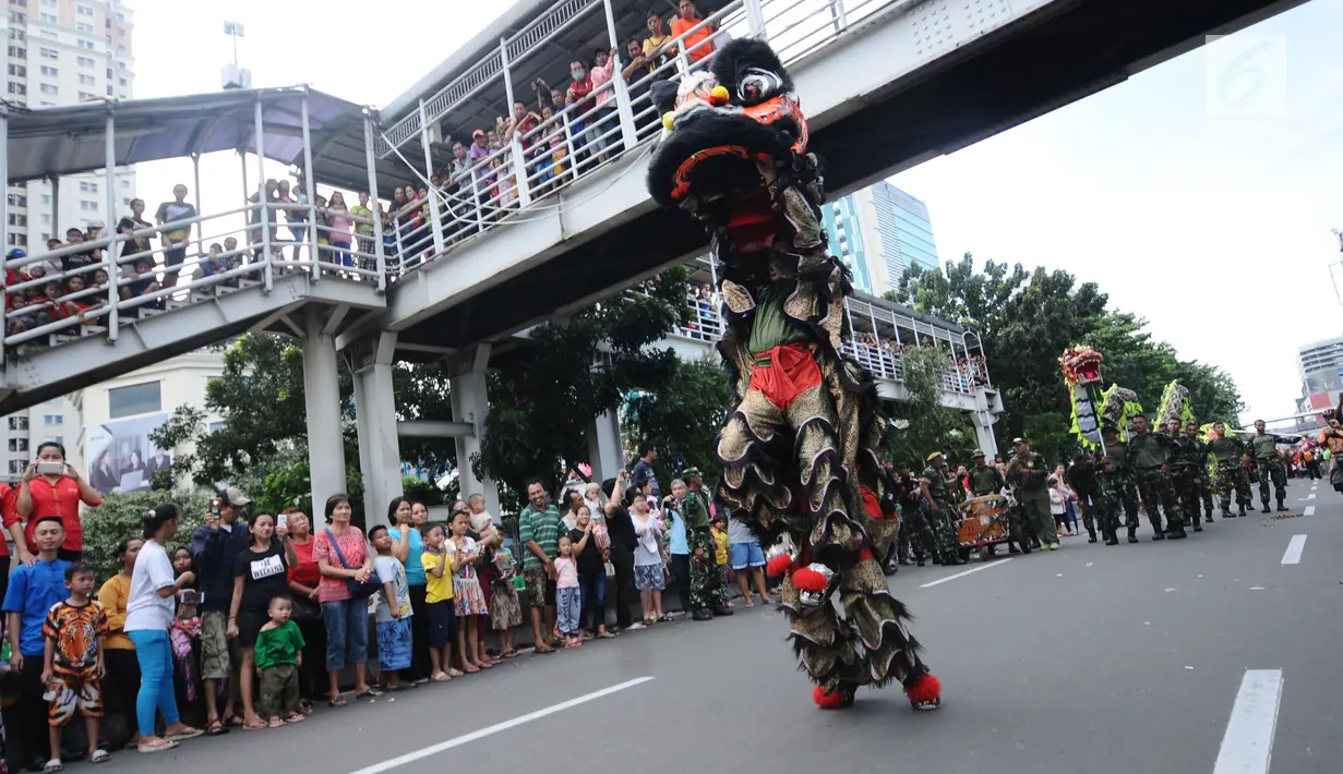 Warga menyaksikan atraksi barongsai di ruas Jalan Gajah Mada, Jakarta saat Karnaval Cap Go Meh 2018, Minggu (4/3). Beragam atraksi budaya ditampilkan dalam karnaval Cap Go Meh 2018 di kawasan Glodok Jakarta. (Liputan6.com/Helmi Fithriansyah)