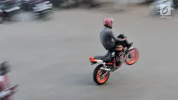 Aksi freestyler motor saat meramaikan waktu menjelang berbuka puasa atau ngabuburit di Banjir Kanal Timur (BKT), Jakarta, Minggu (12/5/2019). Acara ini digelar oleh komunitas freestyle motor gabungan Jakarta-Bekasi. (merdeka.com/Iqbal Nugroho)