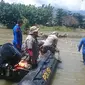 Petugas gebungan sedang mengamati keberadaan buaya berkalung ban target di Sungai Palu, Sabtu (8/2/2020). (Foto: Liputan6.com/Heri Susanto)