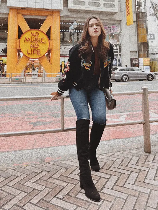 Kalau yang satu ini, style Raisa saat berada di luar negeri. Ia memakai celana jeans yang dipadukan dengan atasan jaket bomber dan long boots hitamnya. (Instagram/raisa6690)
