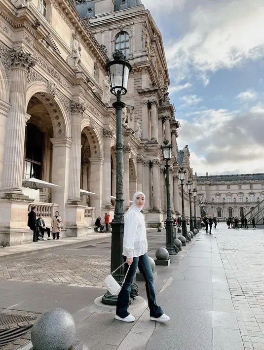 Gaya Citra Kirana saat berada di Paris bisa jadi inspirasi tampil elegan dengan hijab. Citra mengenakan atasan putih yang serasi dengan hijabnya, dipadu celana jeans, sneakers dan tas yang juga putih. [Foto: Instagram/citraciki]