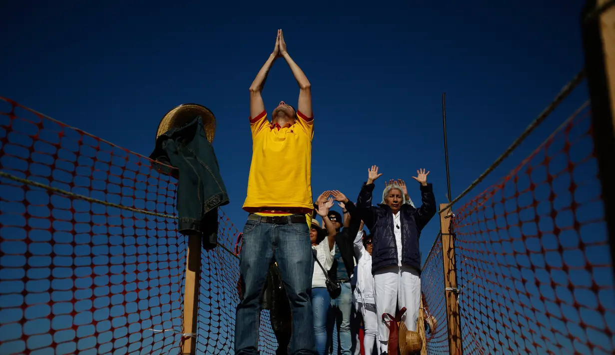Pengunjung merayakan equinox musim semi diatas Piramida Matahari di situs arkeologi Teotihuacan, Meksiko (21/3). Fenomena equinox merupakan peristiwa ketika matahari tepat berada di atas khatulistiwa. (AP Photo/Rebecca Blackwell)