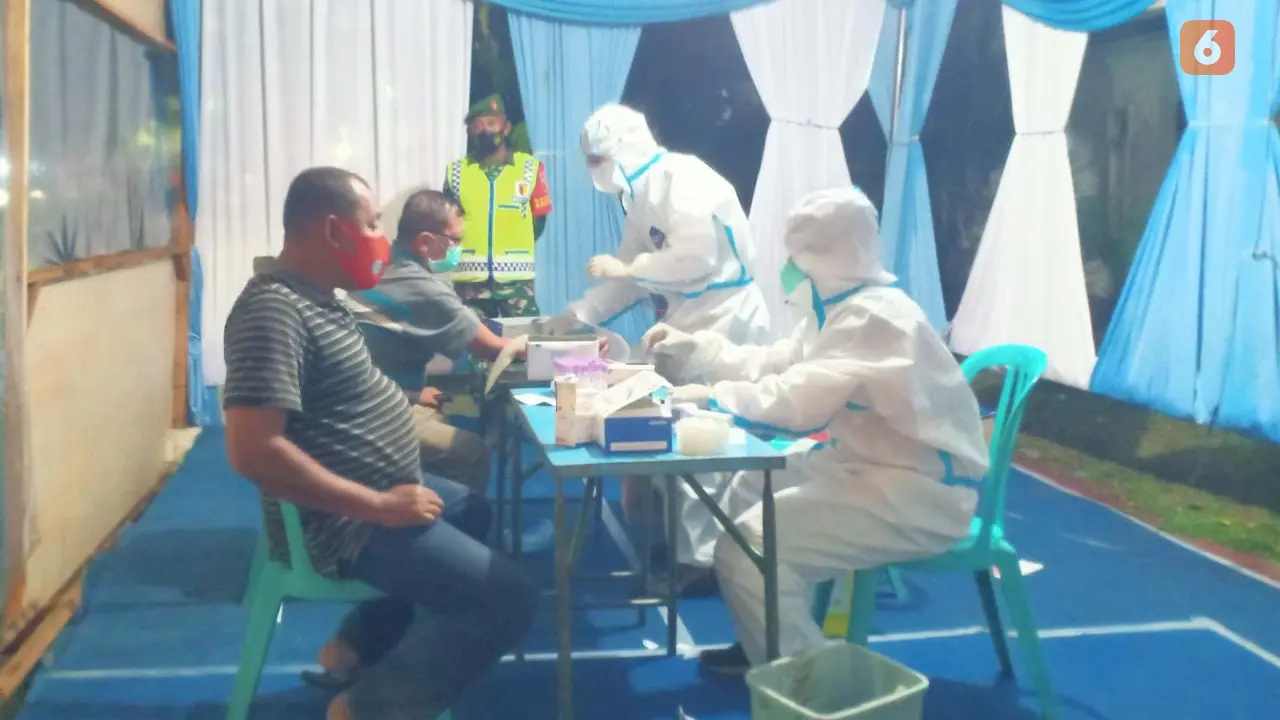 Tenaga kesehatan ketika melakukan rapid test guna mencegah penyebaran Covid-19. (Liputan6.com/Ahmad Adirin)
