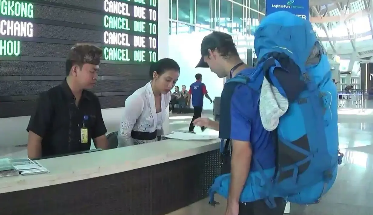 Warga negara asing mencari informasi di Terminal Internasional Bandara Ngurah Rai, Denpasar, Selasa (28/11). Erupsi Gunung Agung yang masih terjadi menyebabkan Bandara Ngurah Rai ditutup 24 jam ke depan sampai Rabu (29/11). (Liputan6.com/Dewi Divianta)