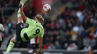 Penyerang Manchester City, Erling Haaland mencetak gol lewat tendangan salto ke gawang Southampton dalam lanjutan Premier League 2022/2023, Sabtu (8/4/2023) malam WIB. (AFP/Adrian Dennis)