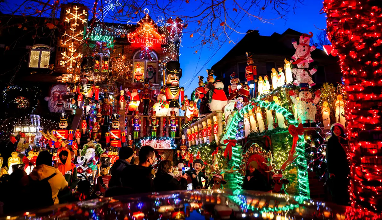 Wisatawan melihat sebuah rumah yang dihiasi lampu Natal di lingkungan Dyker Heights, Brooklyn, New York, Amerika Serikat, 21 Desember 2022. Satu kawasan di Brooklyn, Kota New York, memukau pengunjung dengan lampu hias Natal yang spektakuler. (AP Photo/Julia Nikhinson)