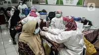 Warga lansia saat disuntik vaksin COVID-19 di SDN 05 Penggilingan, Jakarta, Kamis (25/2/2021). Pemerintah berharap vaksinasi tahap kedua terhadap lansia selesai pada Mei 2021 guna menekan penyebaran COVID-19. (merdeka.com/Iqbal S. Nugroho)