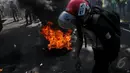 Sebuah ban dibakar saat aksi di depan Istana Presiden, Jakarta, Rabu (20/5/2015). Ribuan mahasiswa menuntut agar Jokowi - JK segera turun. (Liputan6.com/Johan Tallo)