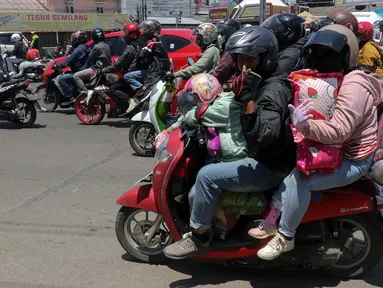 Sejumlah pemudik bersepeda motor melintas di Jalan Raya Brigadir Jenderal Darsono, Cirebon, Jawa Barat, Minggu (7/4/2024). (Liputan6.com/Herman Zakharia)