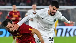 Bek AS Roma Uruguay Matias Vina berebut bola dengan gelandang Ludogorets, Razgrad Cauly Oliveira Souza pada Matchday 6 Grup C Liga Eropa 2022-2023 di Olimpico, Jumat (4/10/2022) dini hari WIB. Berkat hasil ini, Roma berhak mengakhiri penyisihan sebagai runner-up Grup dengan poin 9. (Alberto PIZZOLI / AFP)