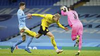 Kiper Manchester City, Ederson, menangkap bola saat duel dengan penyerang Borussia Dortmund, Erling Haaland, pada laga Liga Champions di Stadion Etihad, Rabu (7/4/2021). City menang dengan skor 2-1. (AP/Dave Thompson)