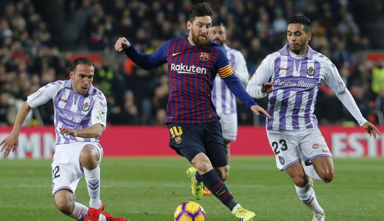 Gelandang Barcelona, Lionel Messi, berusaha melewati kepungan pemain Valladolid pada laga La Liga di Stadion Camp Nou, Barcelona, Sabtu (16/2). Barcelona menang 1-0 atas Valladolid. (AFP/Pau Barrena)