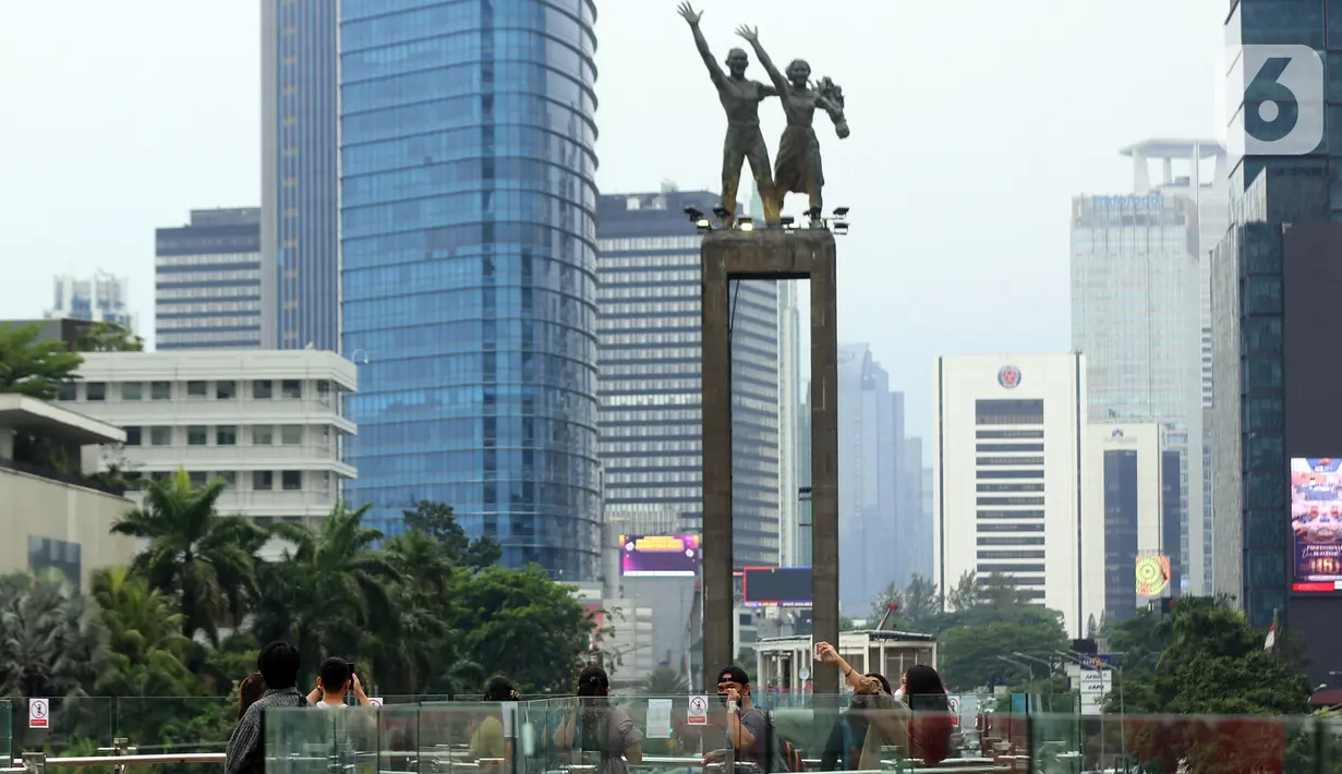 Warga menikmati pemandangan dari anjungan Halte Transjakarta Bundaran HI saat uji coba anjungan itu di kawasan Bundaran Hotel Indonesia, Jakarta, Senin (10/10/2022). Anjungan yang berada di lantai dua Halte Transjakarta Bundaran HI ini dapat menampung 20 orang. (Liputan6.com/Johan Tallo)