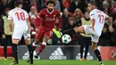 Gelandang Liverpool, Mohamed Salah berebut bola dengan pemain Sevilla, Sergio Escudero dan Pablo Sarabia dalam laga Grup E Liga Champions di Stadion Anfield, Rabu (13/9). Sevilla berhasil menahan imbang Liverpool dengan skor 2-2. (Paul ELLIS / AFP)