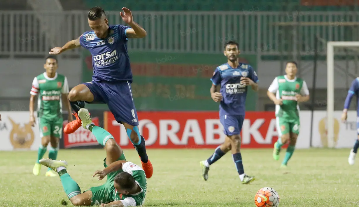 Pemain Arema Cronus, Raphael Maitimo (atas) berebut bola dengan pemain PS TNI, Wawan Febriyanto  pada laga Torabika SC 2016 di Stadion Pakansari, Bogor, Minggu (31/7/2016). (Bola.com/Nicklas Hanoatubun)