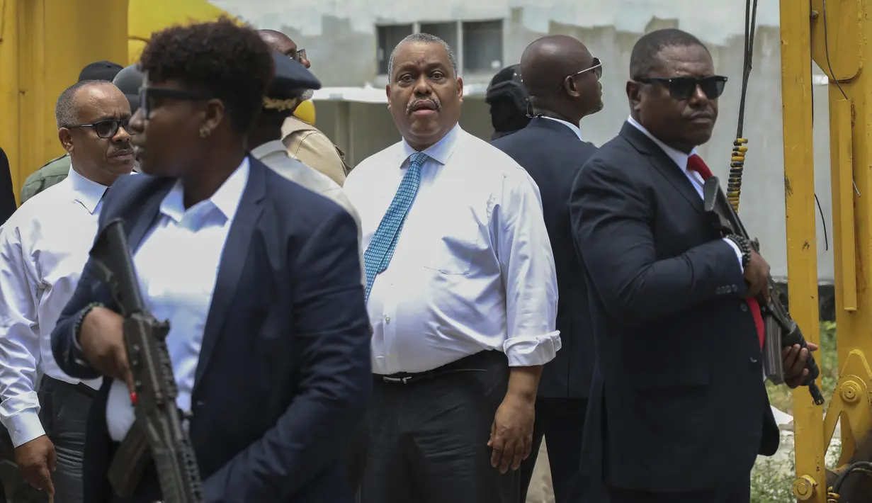 Petugas keamanan bersenjata mengawal Perdana Menteri Haiti Garry Conille saat ia mengunjungi Rumah Sakit Umum di Port-au-Prince, Haiti, Selasa (9/7/2024). (AP Photo/Odelyn Joseph)