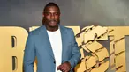 Aktor Idris Elba saat menghadiri pemutaran perdana film Beast di Museum of Modern Art, New York, Amerika Serikat, 8 Agustus 2022. Idris Elba terlihat necis dalam setelan abu-abu-biru saat memimpin para bintang di pemutaran perdana film Beast. (Photo by Evan Agostini/Invision/AP)
