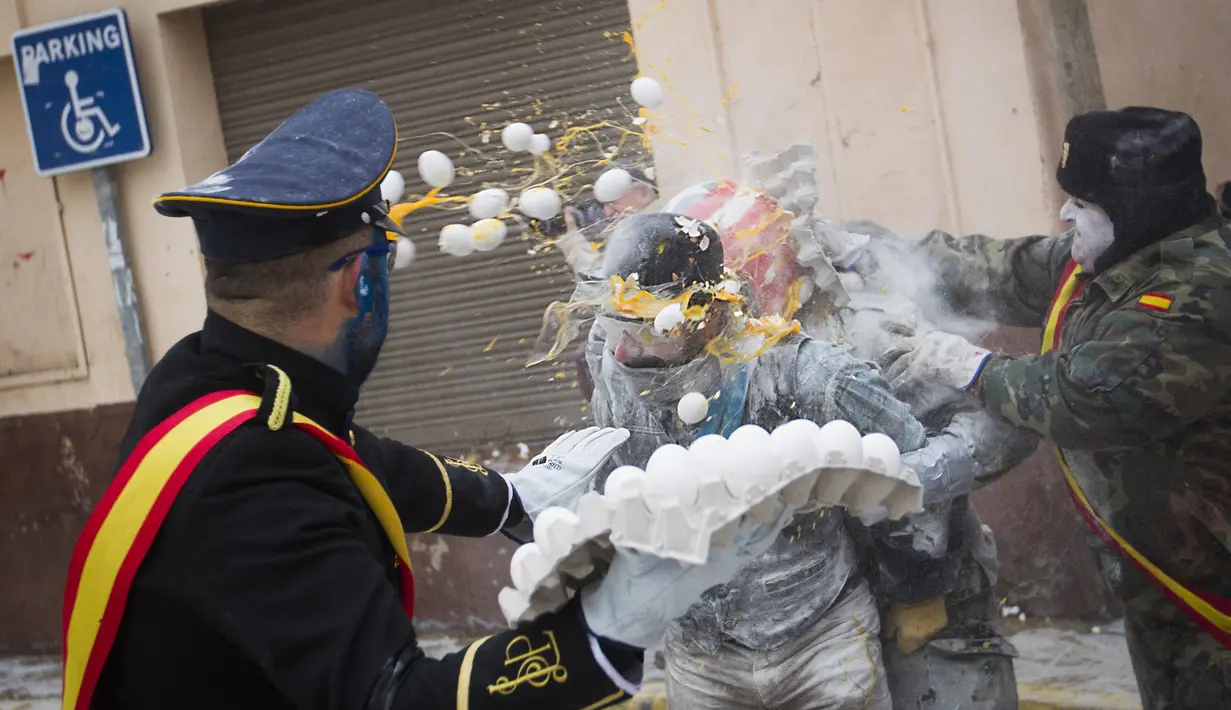Seorang peserta diserang telur oleh peserta lainnya saat Festival Els Enfarinats di kota Ibi, Spanyol, Rabu (28/12). Tradisi ini diyakini telah ada sejak 200 tahun yang lalu. (AFP PHOTO / Jamie Reina)