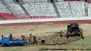 Pekerja memindahkan rumput di Stadion Utama Gelora Bung Karno (SUGBK), Jakarta, Jumat (18/5). Panitia Pelaksana Asian Games 2018 (INASGOC) memindahkan rumput SUGBK ke area panahan hingga selesai upacara pembukaan Asian Games. (Liputan6.com/Johan Tallo)