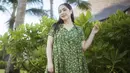 <p>Nagita Slavina tampil elegan mengenakan dress panjang warna hijau army dengan motif bunga-bunga warna kuning. Credit: Instagram (@raffinagita1717)</p>