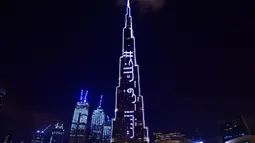 Pencakar langit Burj Khalifa menyala dengan pesan "Stay Home" di Dubai pada Selasa (24/3/2020). Gedung pencakar langit tertinggi di dunia itu menyala dengan slogan kampanye #STAYHOME yang mendesak warga untuk mematuhi langkah-langkah pencegahan di tengah pandemi COVID-19. (Giuseppe CACACE/AFP)