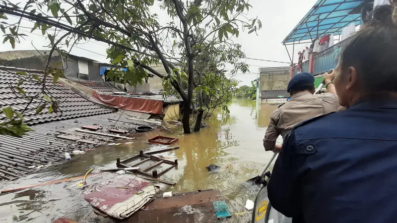 Kali Ledug di Tangerang meluap ke pemukiman warga akibat tanggul jebol. (Liputan6.com/Pramita Tristiawati)