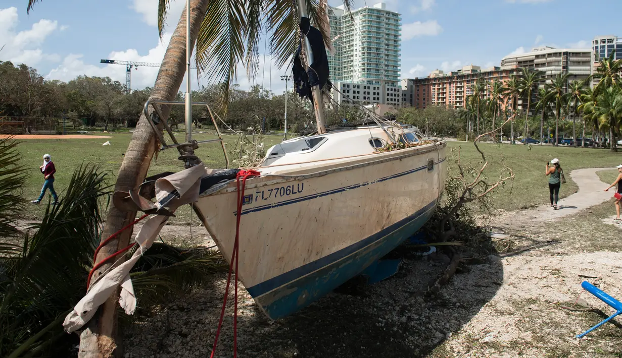 Sebuah kapal terhempas ke daratan akibat terhempas badai Irma di Coconut Grove, Florida, Senin (11/9). Badai Irma menghantam negara bagian Florida dengan kecepatan angin mencapai 200 km/jam. (SAUL LOEB/AFP)