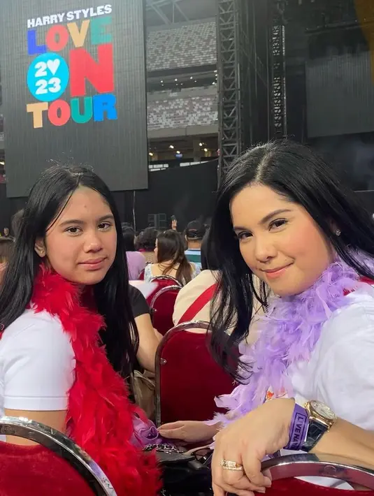 Nonton konser Harry Styles, Annisa Pohan kompak dengan putrinya mengenakan baju atasan putih dan syal bulu-bulu warna cerah.  [@annisayudhoyono]