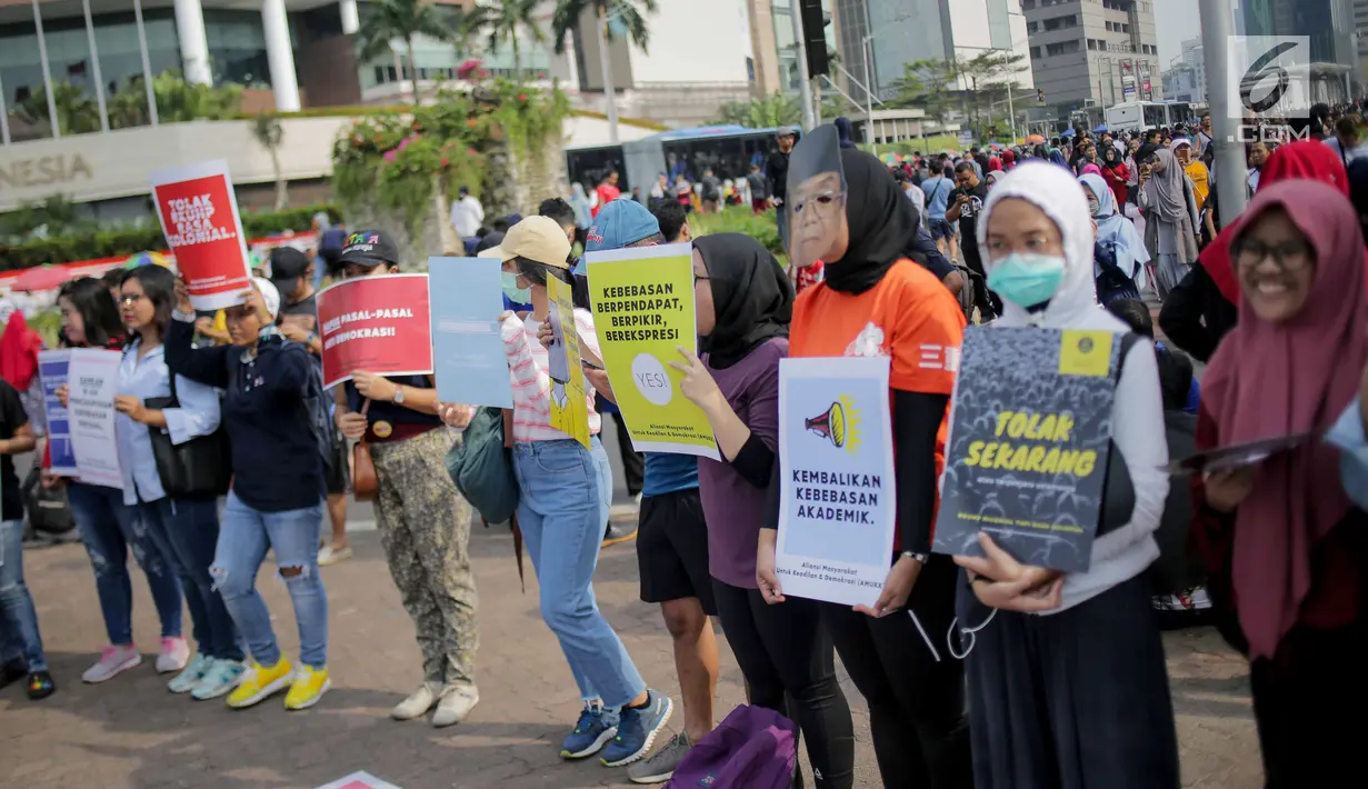 Massa yang tergabung dalam Aliansi Masyarakat Sipil untuk Keadilan dan Demokrasi menggelar aksi saat car free day (CFD) di kawasan Bundaran HI, Jakarta, Minggu (15/9/2019). Massa mengatakan RUU KUHP berpotensi digunakan untuk mengkriminalisasi korban kekerasan seksual. (Liputan6.com/Faizal Fanani)