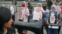 Sejumlah ibu-ibu di Bandung mengangkat poster-poster berisi protes kepada aparat atas dugaan represifitas saat mengamankan demonstrasi beberapa waktu lalu. (Liputan6.com/Huyogo Simbolon)