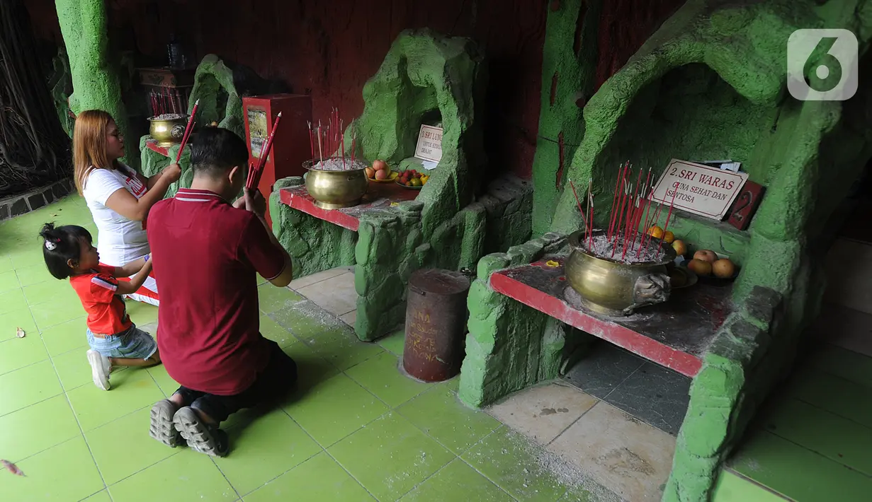 Warga bersembahyang selama perayaan Tahun Baru Imlek 2571 di Vihara Gayatri, Depok, Sabtu (25/1/2020). Vihara Gayatri ini memiliki satu ciri khas yang membedakan dengan Vihara lain, yakni keberadaan tujuh sumur yang ada sejak Vihara berdiri tahun 1984. (merdeka.com/Arie Basuki)