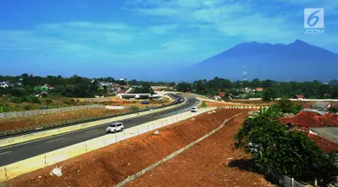 Kendaraan melintasi tol dengan latar belakang Gunung Salak saat Tol Fungsional Bocimi seksi 1 Ciawi-Cigombong dibuka menuju arah Ciawi di kawasan Ciawi Bogor (20/6). (Merdeka.com/ Arie Basuki)