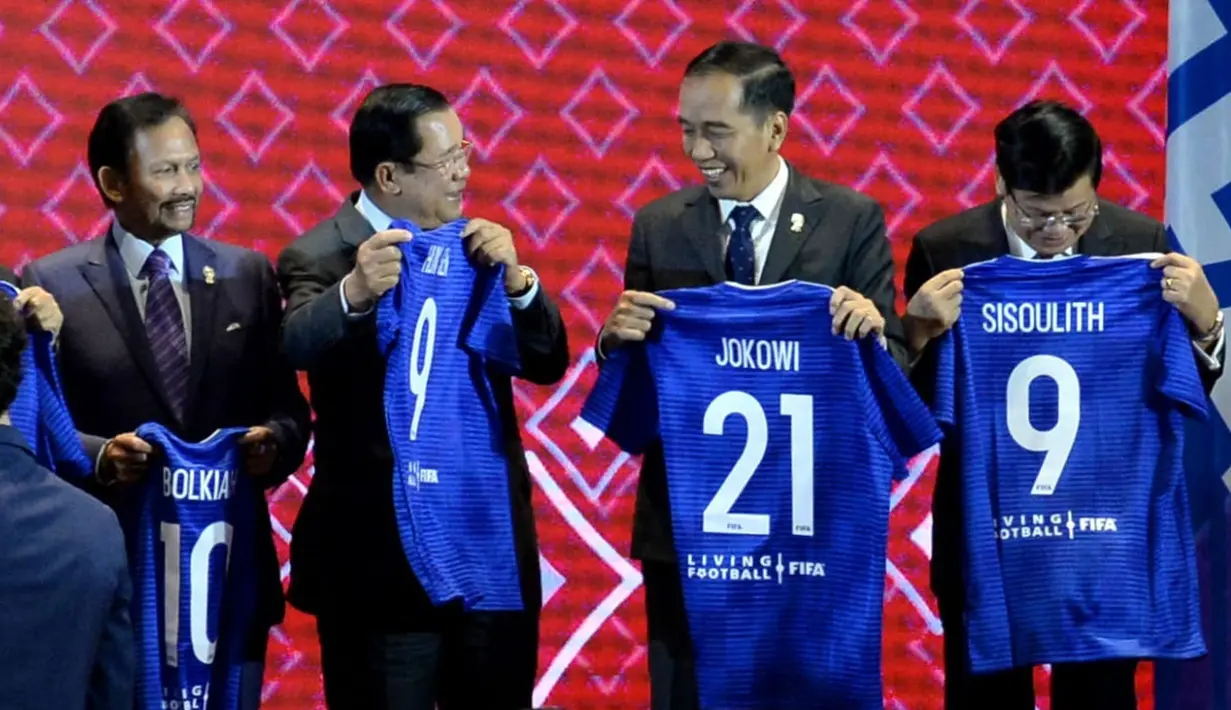 Presiden Joko Widodo menunjukkan jersey pada acara penandatanganan Nota Kesepahaman antara FIFA dan ASEAN di Bangkok, Sabtu (2/11/2019). Jokowi mendapat nomor punggung 21 karena keberhasilan Indonesia ditunjuk sebagai tuan rumah Piala Dunia U-20 pada 2021 mendatang. (Liputan6.com/Biro Pers Setpres)