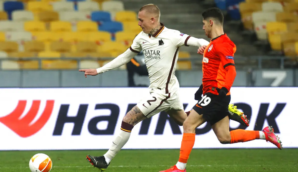 Pemain AS Roma Rick Karsdorp (kiri) memperebutkan bola dengan pemain Shakhtar Donetsk Manor Solomon pada pertandingan leg kedua babak 16 besar Liga Europa di Stadion Olimpiyskiy, Kyiv, Ukraina, Kamis (18/3/2021). AS Roma menang dengan skor 2-1. (AP Photo/Efrem Lukatsky)